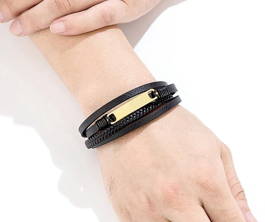 Pulseira masculina de couro preto trançado com placa dourada no pulso